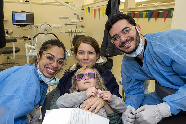 Ashiana Jivraj, DMD21, gives care to a pediatric patient at annual Give Kids a Smile event.