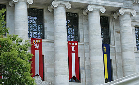 Flags displayed between. the columns of Gordon Hall.
