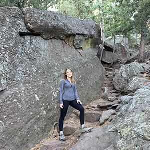 Abby Marshall, DMD24, out hiking in the woods.