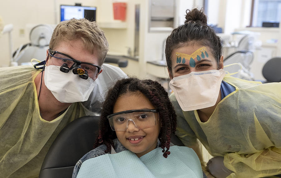 DMD student dentists with young patient