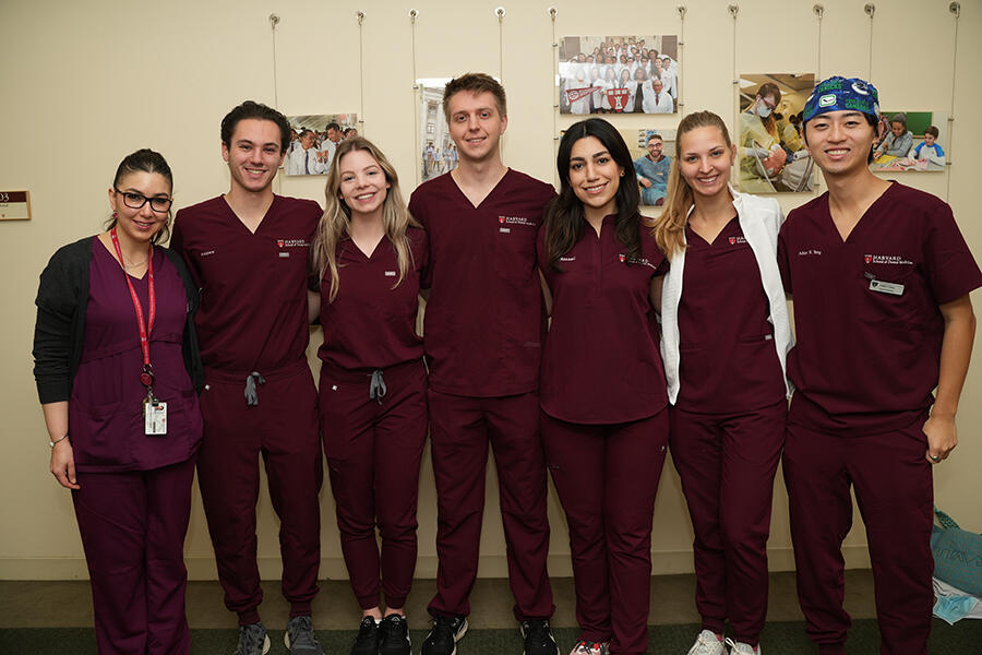 faculty and students in scrubs