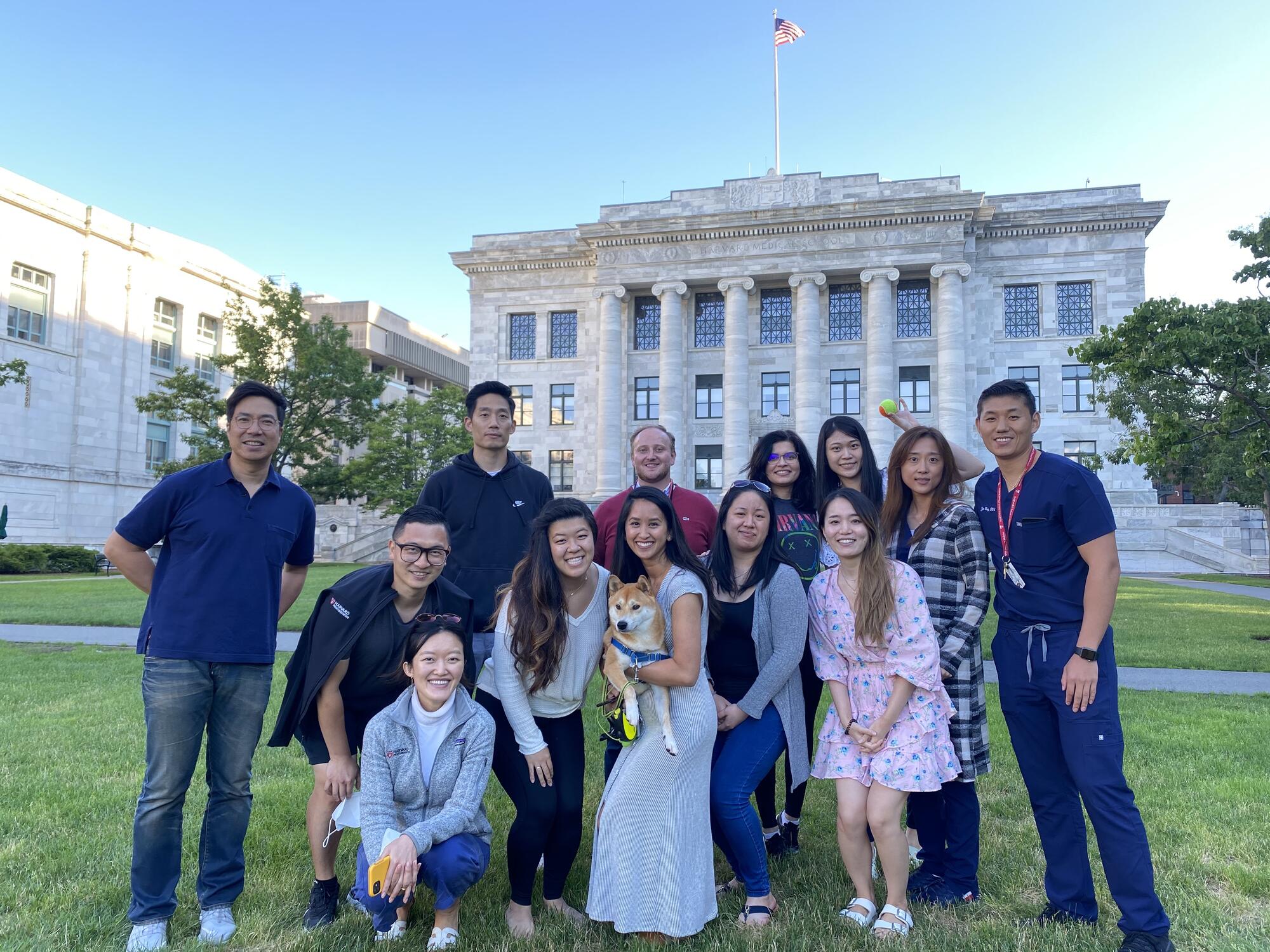 Group of students outside posing in front of the Harvard Medical School