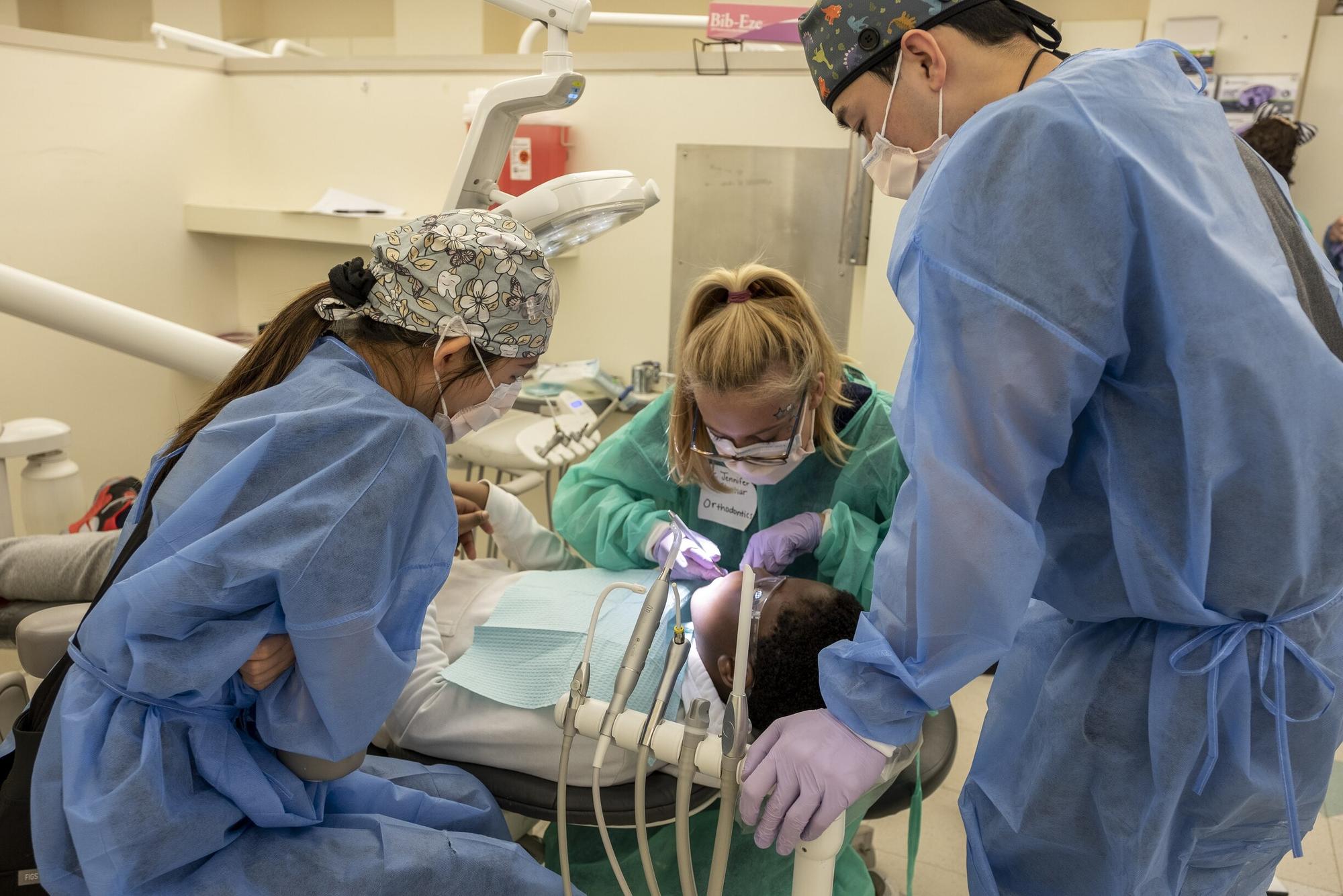 A dentist working with a young patient