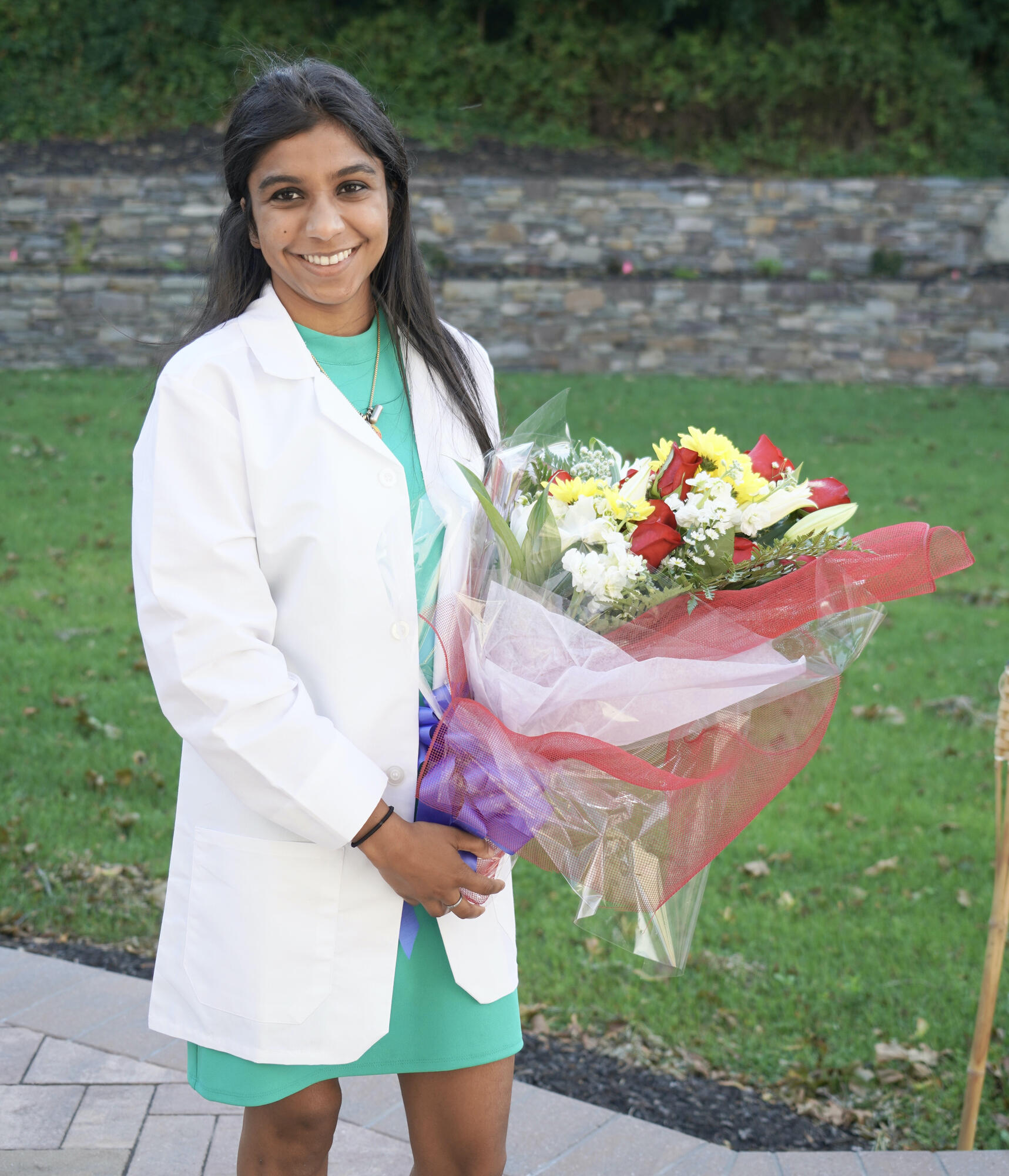 Sapna Nath, DMD24, celebrates her virtual White Coat Ceremony at home with family and friends.