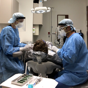 Two providers working on dental patient