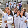 students in white coats taking selfie