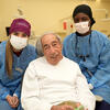 student dentists with elderly veteran