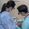 Patient receiving dental treatment from dentists