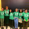 Members of the HSDM Green Team and Sustainability Committee pose together at an event promoting reusable mugs.