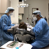 Two providers working on dental patient