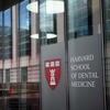 The Harvard School of Dental Medicine logo on the side of a glass building